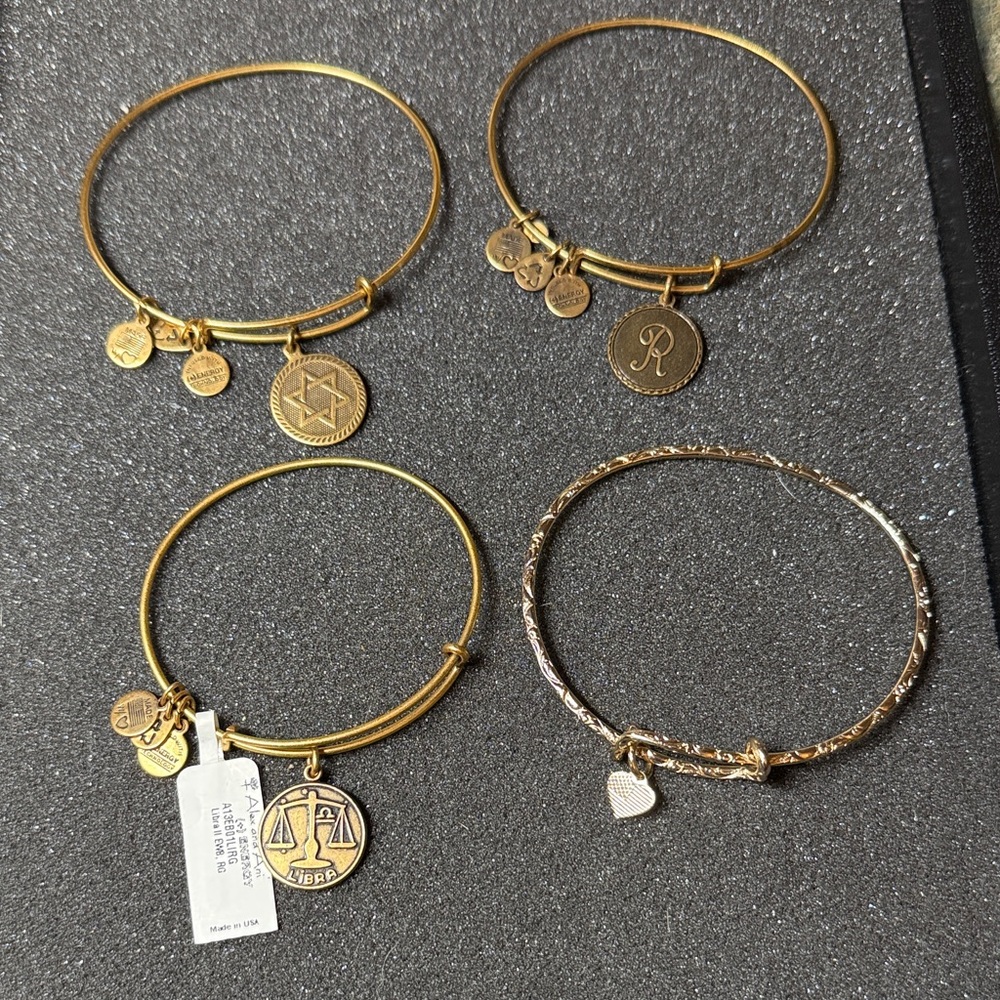 Gold Alex and Ani bundle. Four bracelets one is new with tags